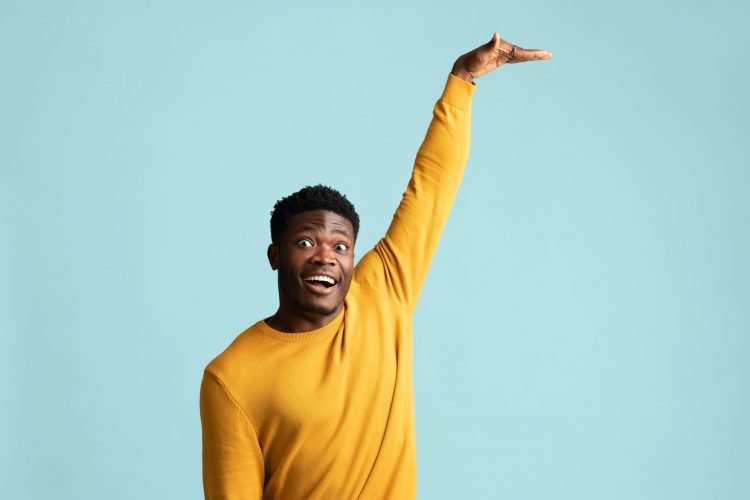 Excited black guy showing height of something