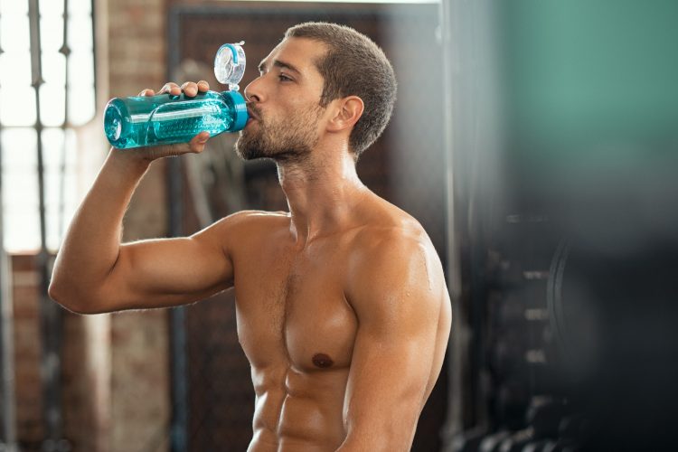 Fitness man drinking from water bottle