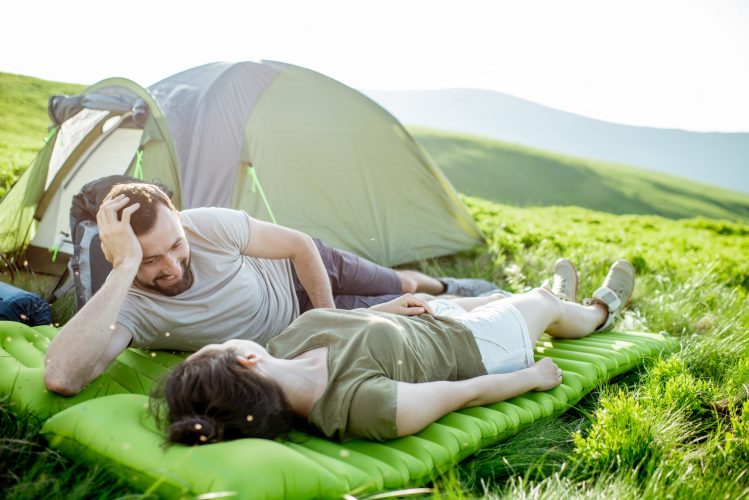 Couple relaxing at the campsite in the mountains