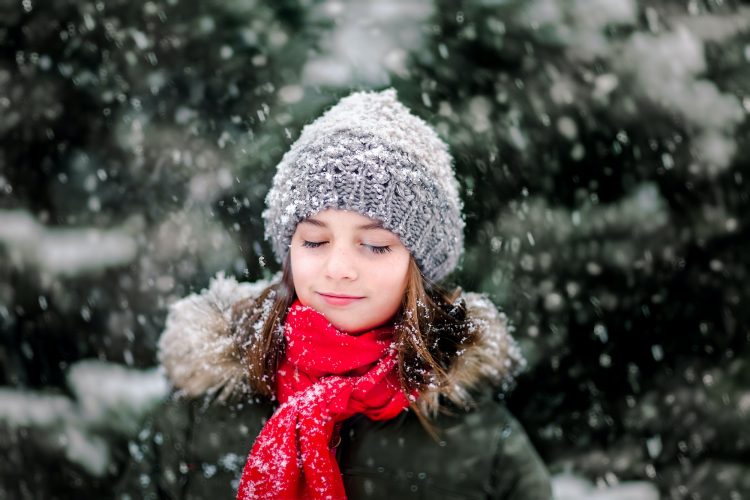 Portrait of girl in falling snow