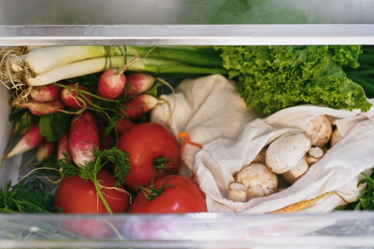 Zero waste grocery in fridge. Fresh vegetables in opened drawer in refrigerator