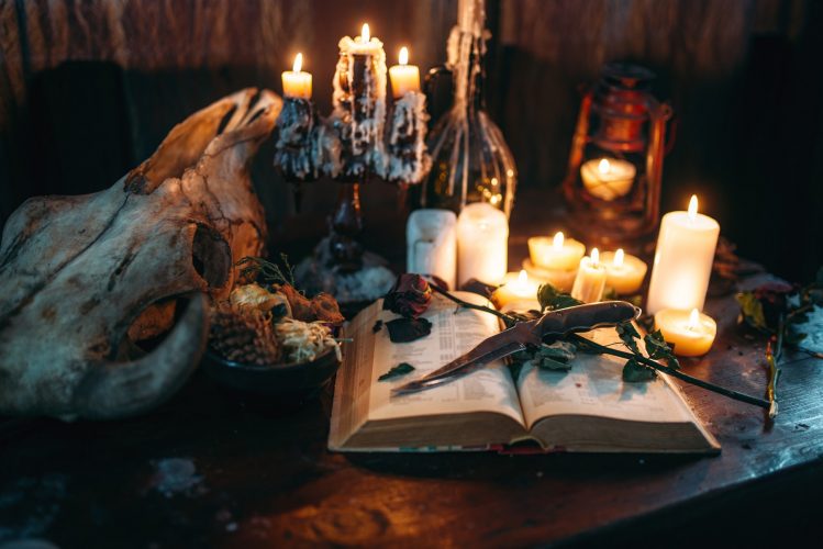 Witchcraft, dark magic, candles with ritual book