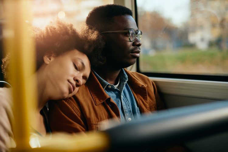 African American couple traveling by bus together.