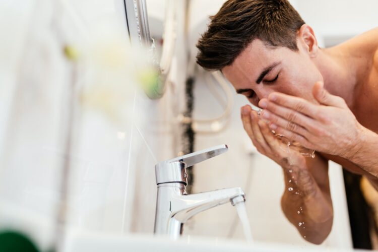 Man washing face in morning