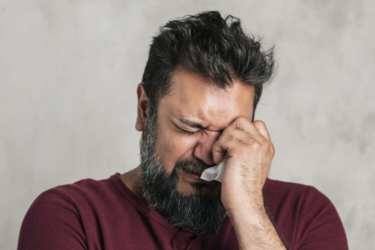 Sick emotional Indian man crying