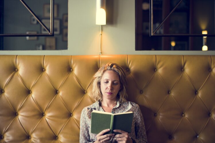 Blond woman reading a book