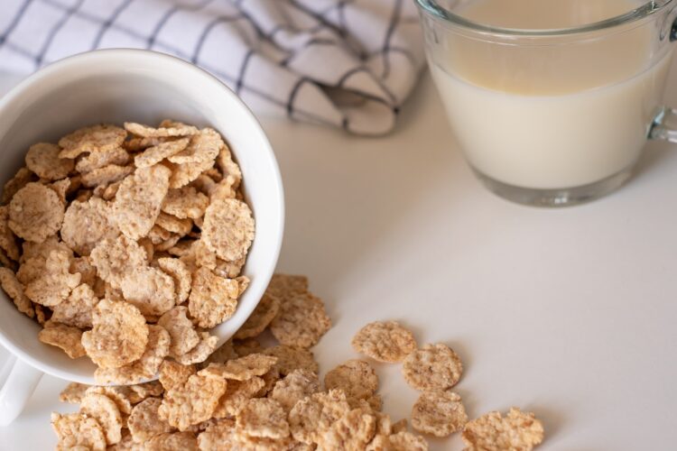 Whole grain cereal flakes and milk. Wholegrain breakfast cereals isolated on a white background