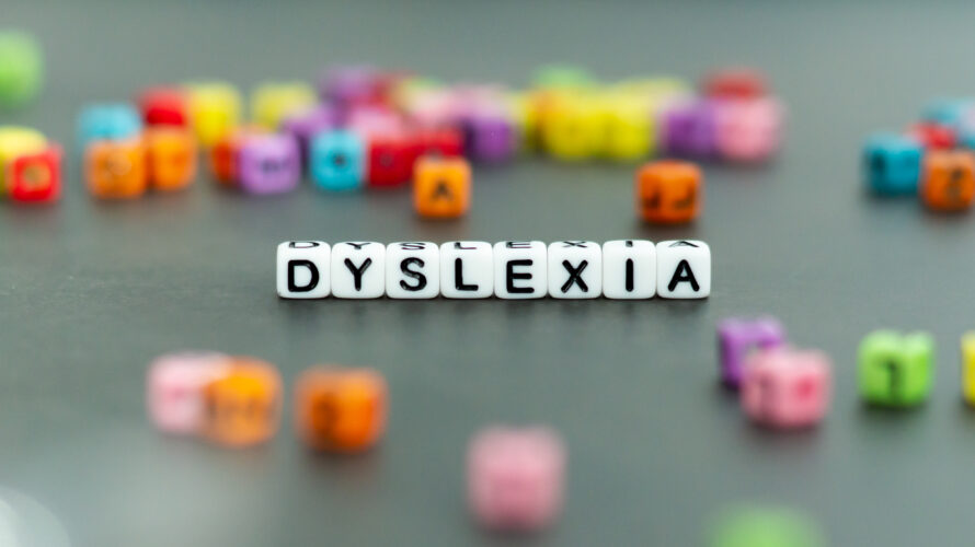 Dyslexia word in white letter block beads. Front view. Dyslexia concept.