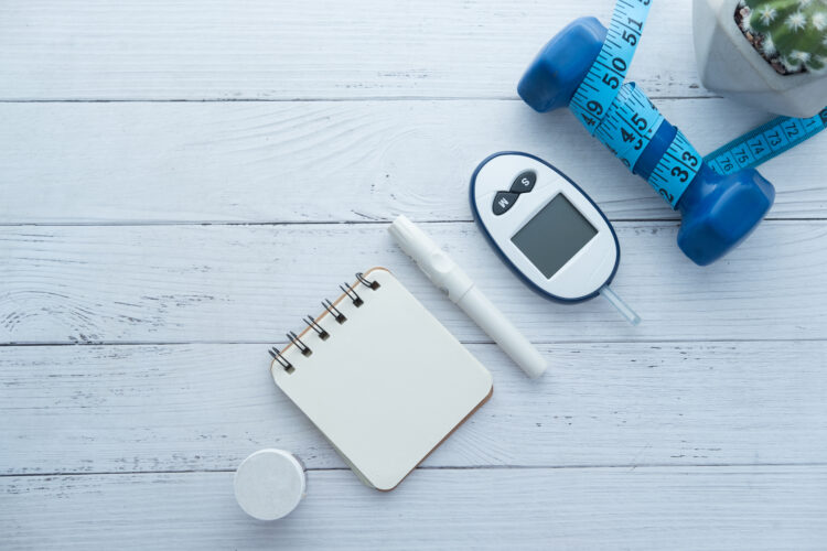 blood sugar measurement kits for diabetes with dumbbell on table