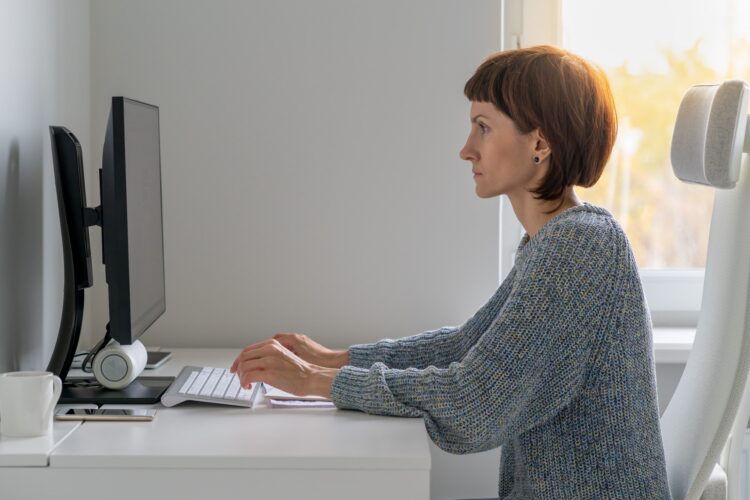 Correct posture and sitting position at computer desk at safe distance from monitor